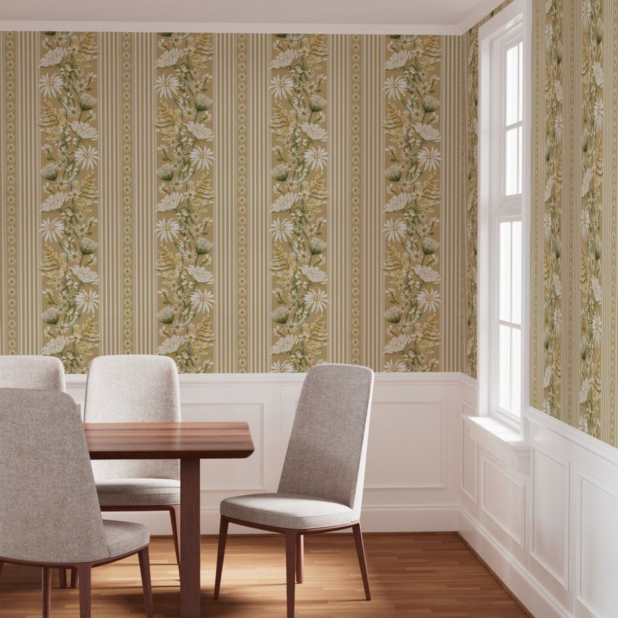 A dining room corner featuring wallpaper with vertical stripes and white daisy floral motifs in beige, warm yellow, and cream. The room includes a wooden dining table and four upholstered dining chairs and dark wood legs, set against a white wainscoted wall and a bright window.